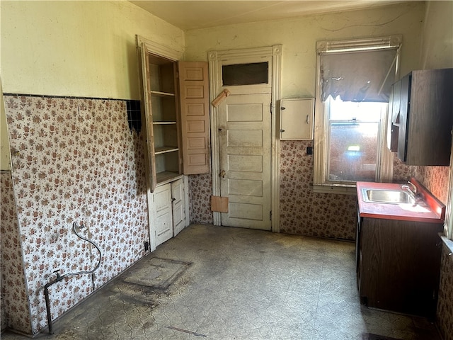 kitchen with sink, tile patterned flooring, and dark brown cabinets