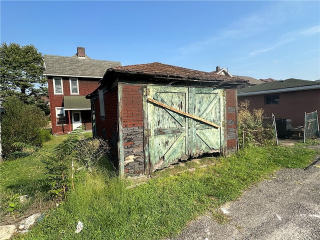 view of side of property with a shed