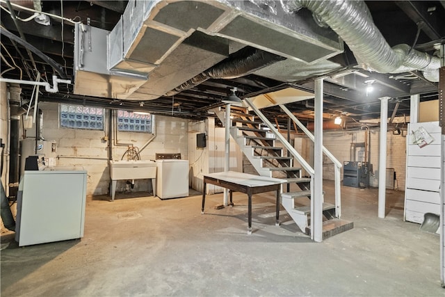 basement with sink and washing machine and clothes dryer