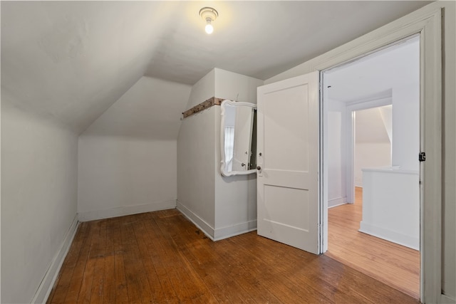 bonus room featuring vaulted ceiling and wood-type flooring