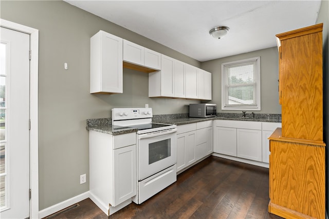 kitchen featuring dark hardwood / wood-style flooring, white cabinetry, and electric range