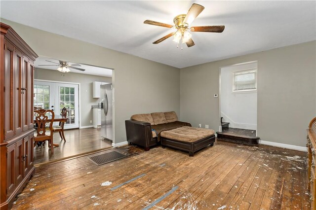 sitting room featuring ceiling fan, french doors, and hardwood / wood-style floors