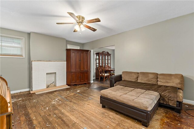 living room with a fireplace, ceiling fan, and hardwood / wood-style flooring