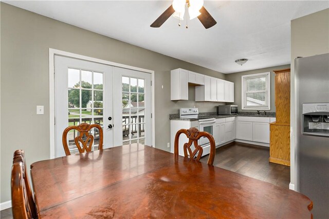 dining space featuring ceiling fan, french doors, dark hardwood / wood-style floors, and a healthy amount of sunlight