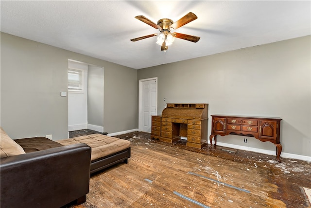 living room featuring hardwood / wood-style floors and ceiling fan