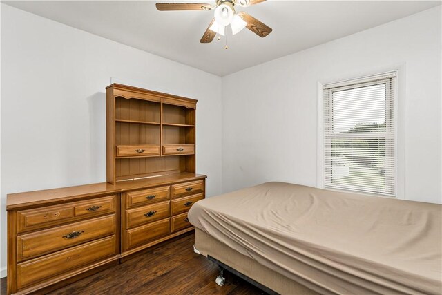 bedroom with ceiling fan and dark hardwood / wood-style floors