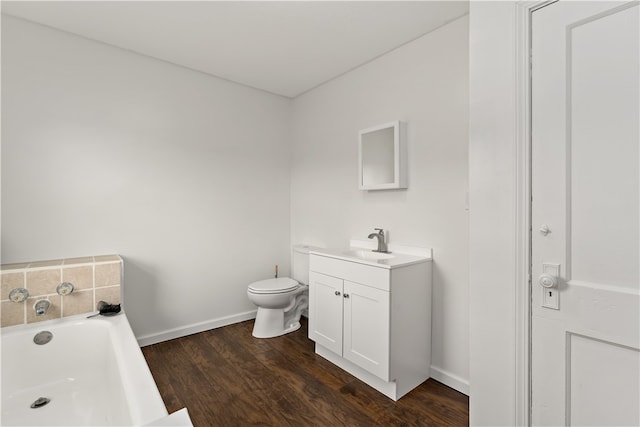 bathroom with toilet, a bathtub, vanity, and wood-type flooring