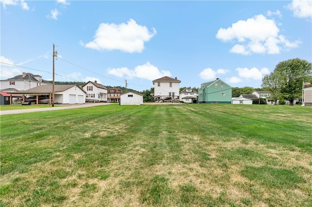 view of yard with a carport and a garage