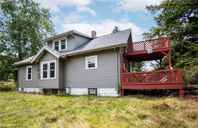 rear view of house featuring a wooden deck