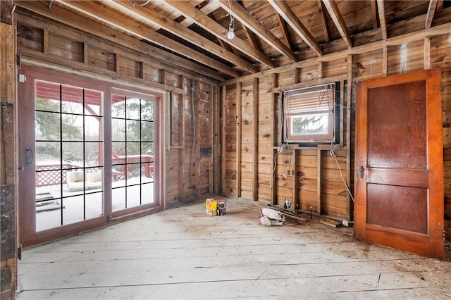 miscellaneous room featuring wood walls, light wood-type flooring, and wooden ceiling