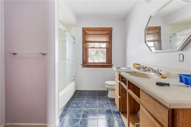 full bathroom featuring combined bath / shower with glass door, vanity, and toilet