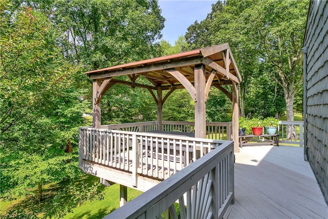 wooden terrace featuring a gazebo