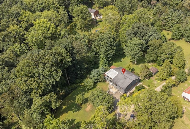 birds eye view of property featuring a view of trees