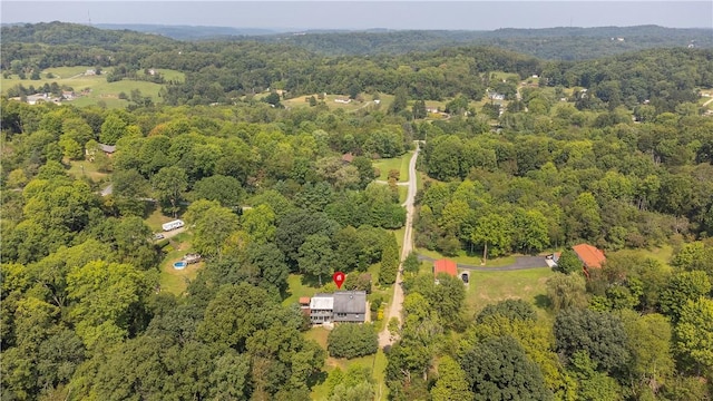 bird's eye view with a wooded view