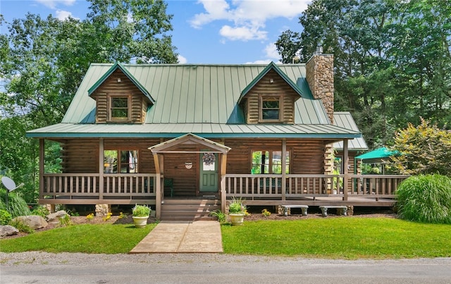 log-style house featuring a chimney, log siding, and a porch