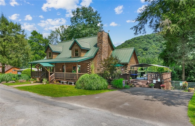 view of side of property featuring a yard and covered porch