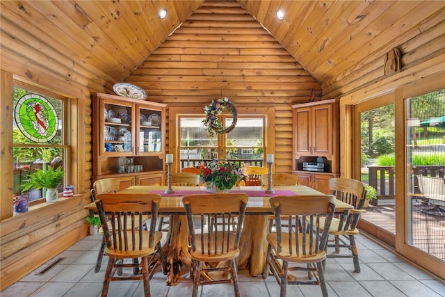 dining area with rustic walls, wooden ceiling, and light tile patterned floors