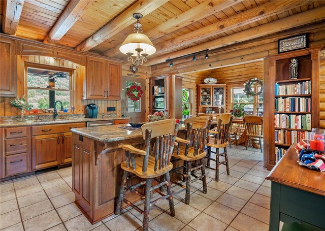 kitchen with hanging light fixtures, light tile patterned floors, wooden ceiling, and a healthy amount of sunlight