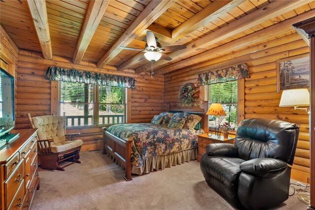 carpeted bedroom with multiple windows, beamed ceiling, log walls, and wooden ceiling