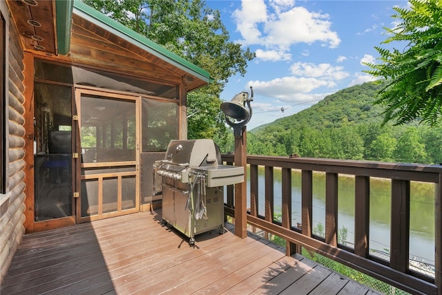 wooden deck featuring a grill and a water view