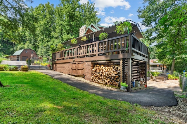 view of home's exterior with a yard and a deck