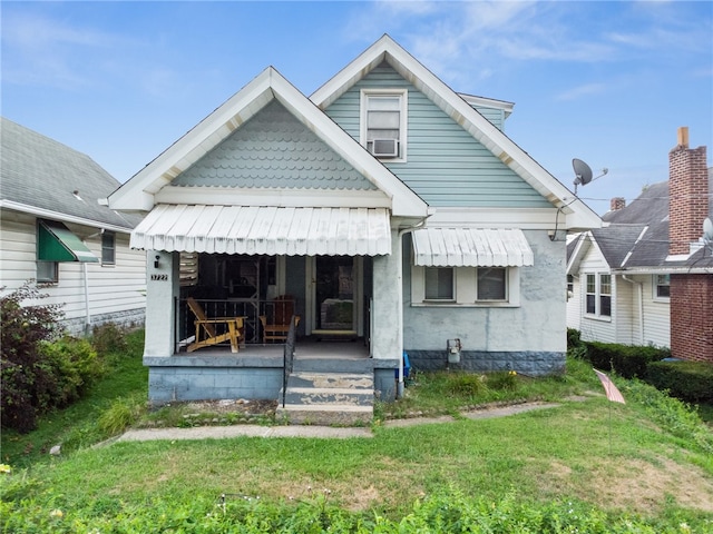 rear view of property with a lawn and cooling unit