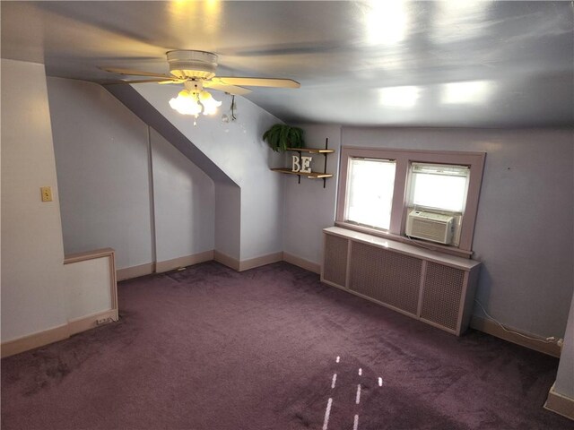 bonus room featuring dark colored carpet, ceiling fan, lofted ceiling, and radiator