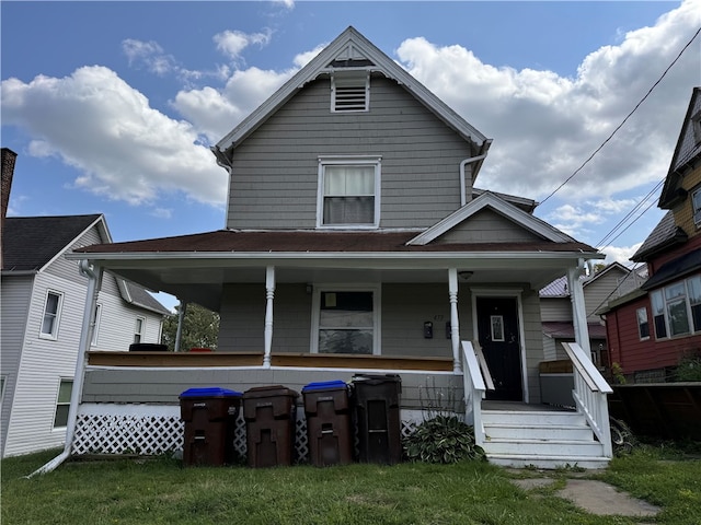 view of front facade with a front yard and a porch