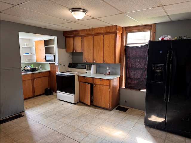 kitchen featuring light tile patterned floors, black refrigerator with ice dispenser, a paneled ceiling, and electric stove