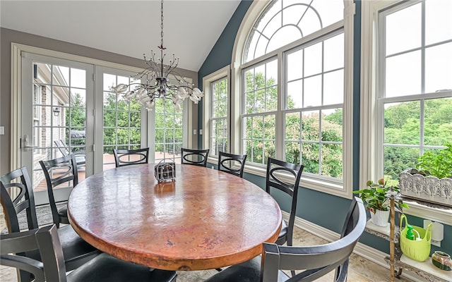 dining space featuring lofted ceiling and a notable chandelier