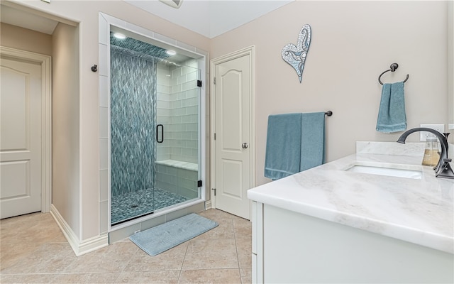 bathroom with tile patterned floors, vanity, and walk in shower