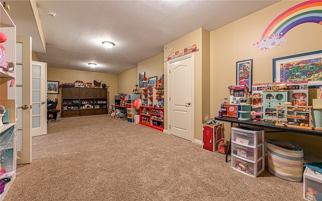 rec room featuring carpet flooring and a textured ceiling