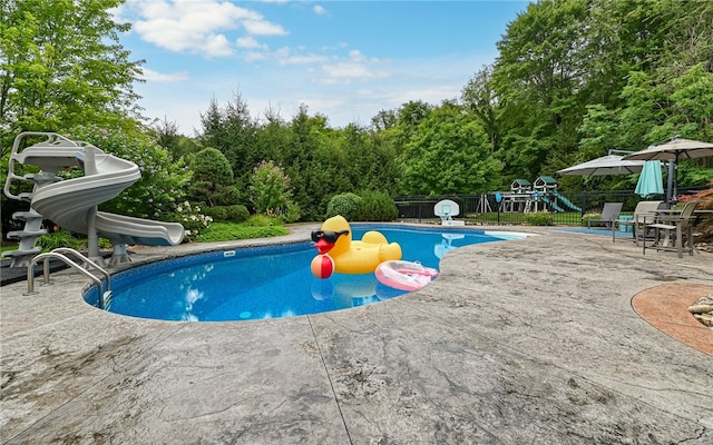 view of pool featuring a patio area and a playground