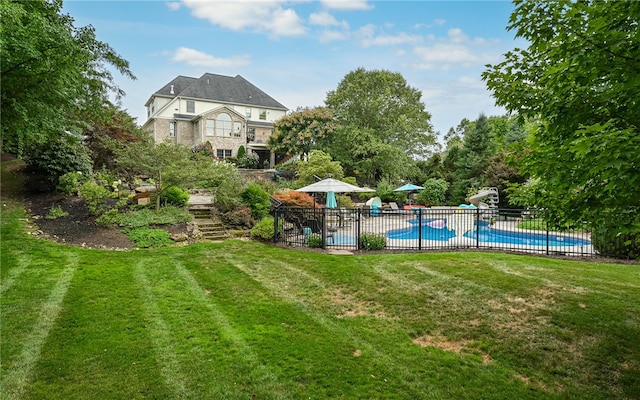 exterior space with a fenced in pool and a patio area