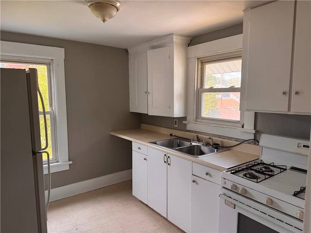 kitchen with a wealth of natural light, refrigerator, and white gas range