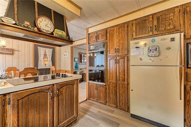 kitchen featuring light hardwood / wood-style flooring and black appliances