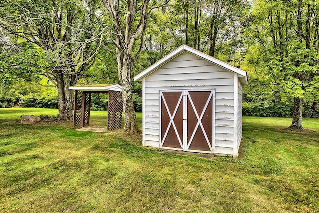 view of outbuilding featuring a lawn