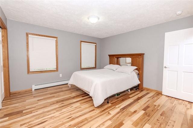 bedroom featuring light hardwood / wood-style flooring and a baseboard radiator