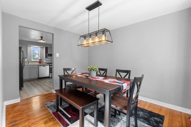 dining area featuring sink and light hardwood / wood-style flooring