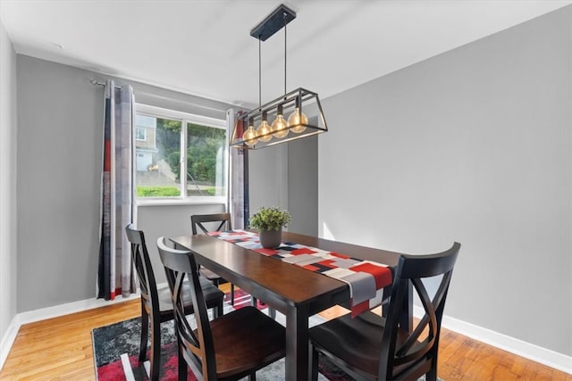 dining room featuring light hardwood / wood-style flooring and a chandelier