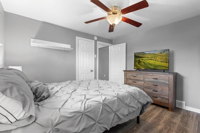 bedroom featuring ceiling fan and dark wood-type flooring