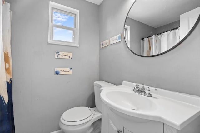 bathroom featuring toilet and vanity