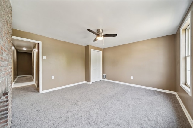 spare room with carpet floors and ceiling fan