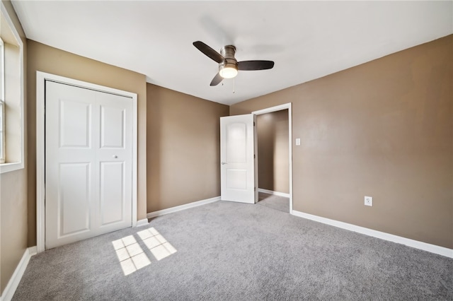 unfurnished bedroom featuring ceiling fan, a closet, and light carpet