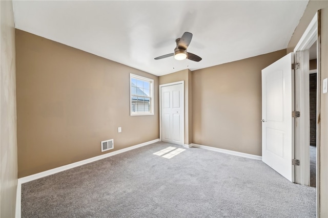 unfurnished bedroom featuring a closet, ceiling fan, and light carpet