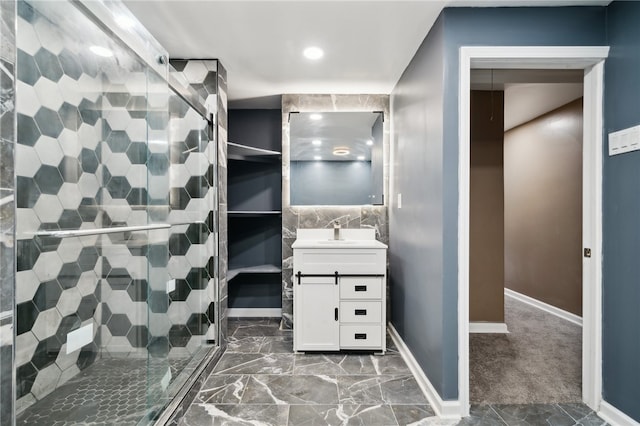 bathroom featuring tile patterned flooring, vanity, and a shower with shower door