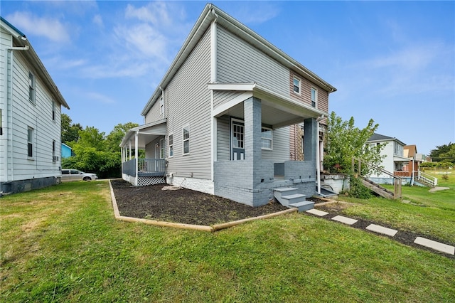 back of house with a lawn