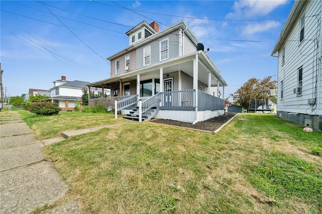 view of front facade with covered porch and a front yard