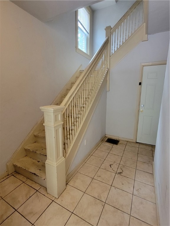 staircase with tile patterned floors