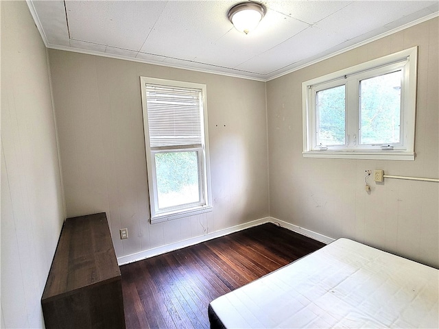 unfurnished bedroom with crown molding and hardwood / wood-style floors